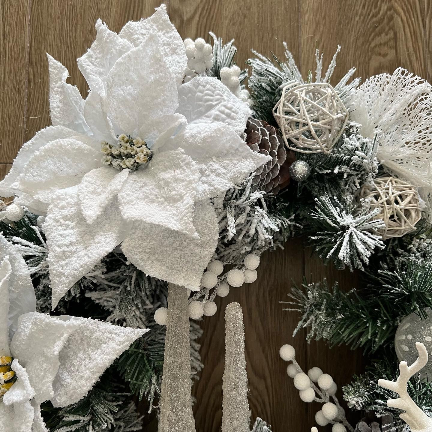White winter wreath with Ferns and Poinsettias
