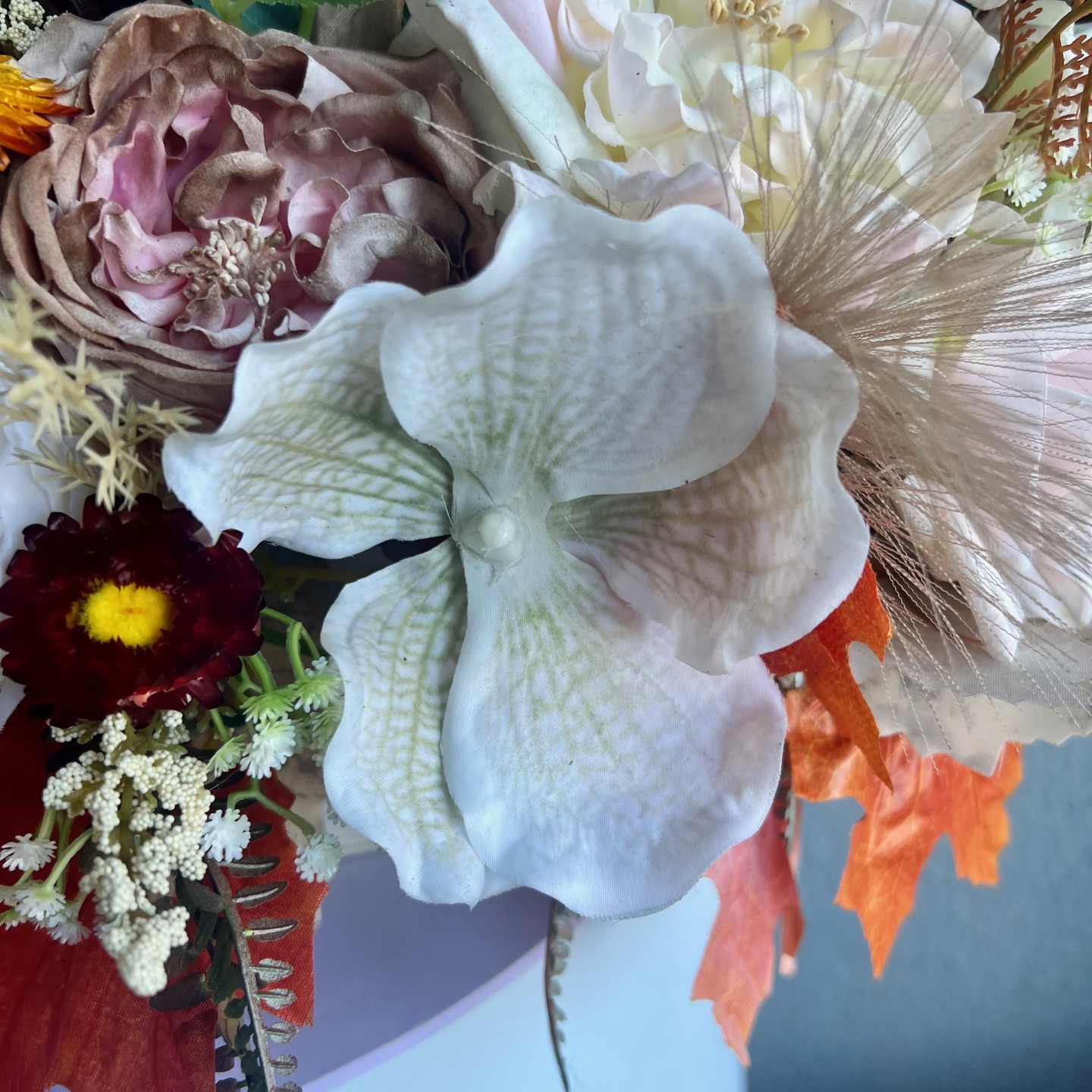 Thanksgiving table centrepiece with artificial flowers