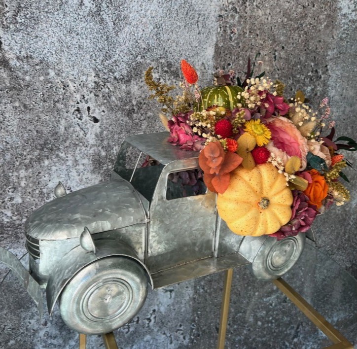 Thanksgiving arrangement with preserved flowers in iron car