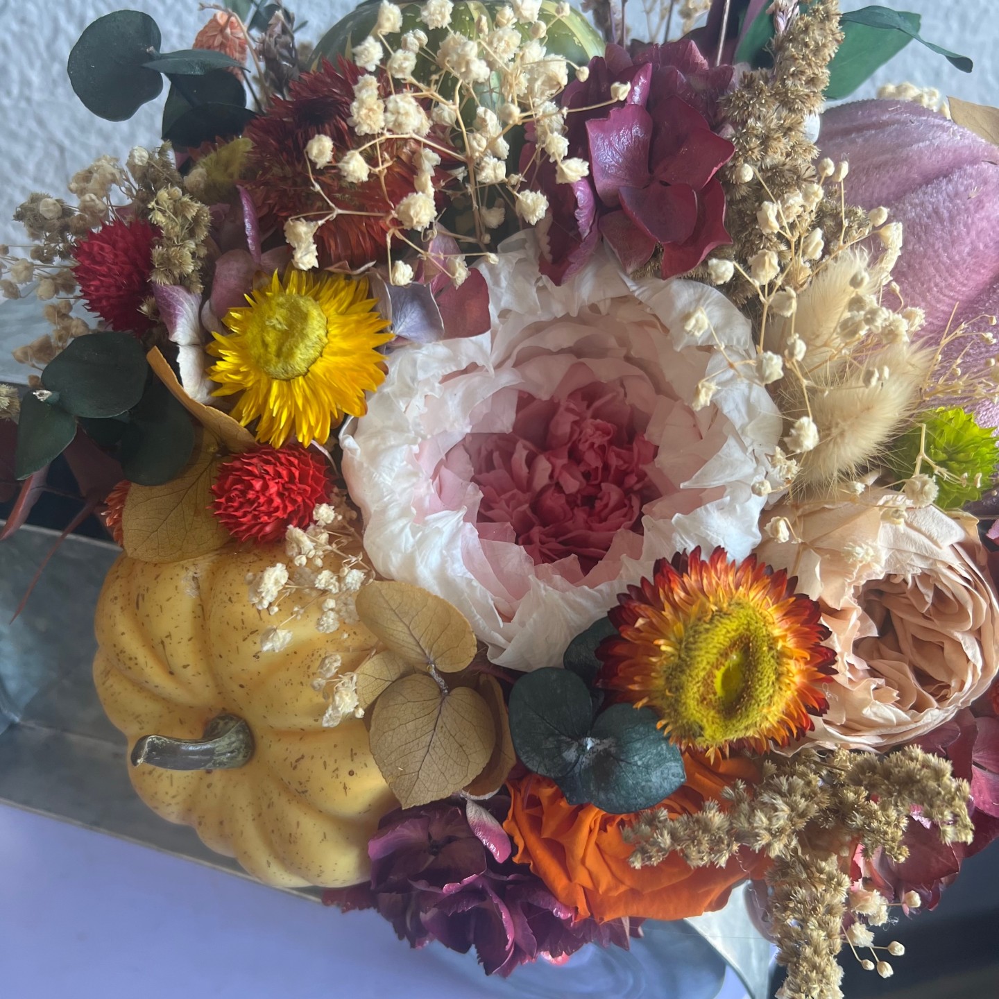 Thanksgiving arrangement with preserved flowers in iron car