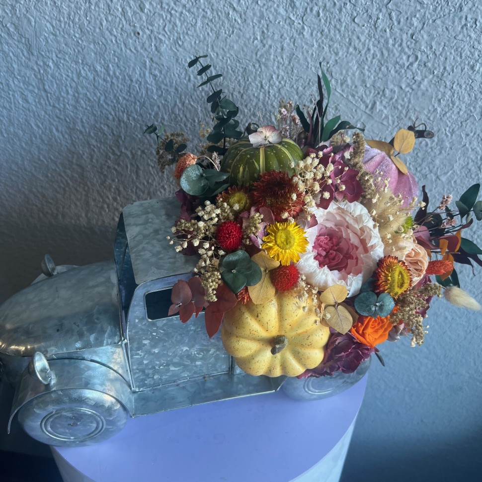 Thanksgiving arrangement with preserved flowers in iron car