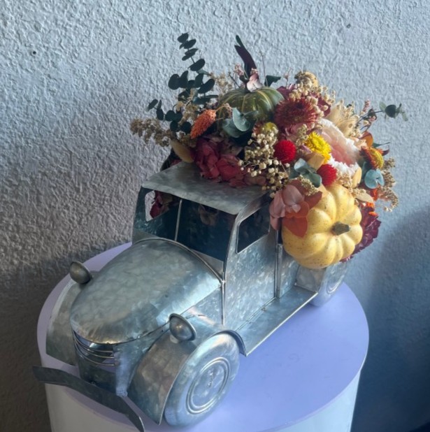 Thanksgiving arrangement with preserved flowers in iron car