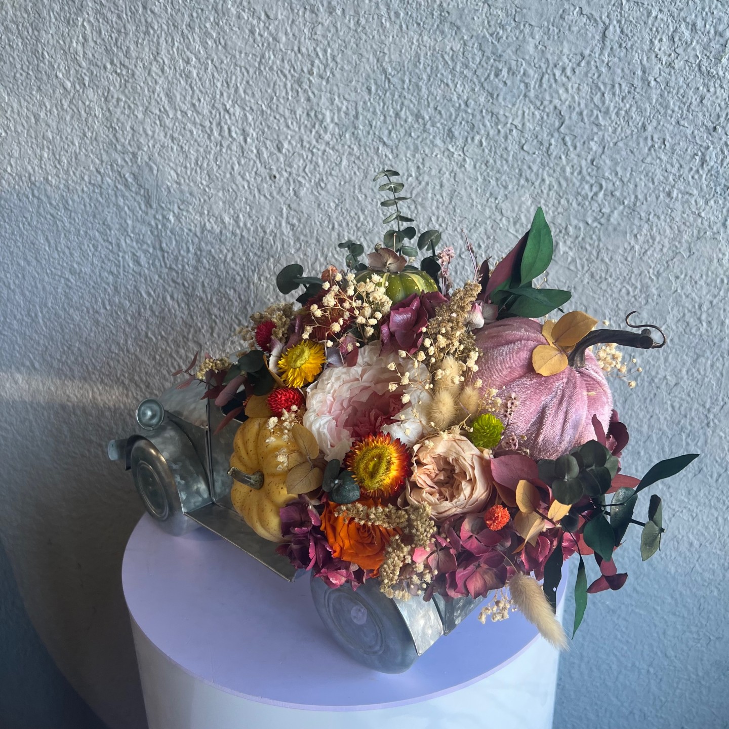 Thanksgiving arrangement with preserved flowers in iron car