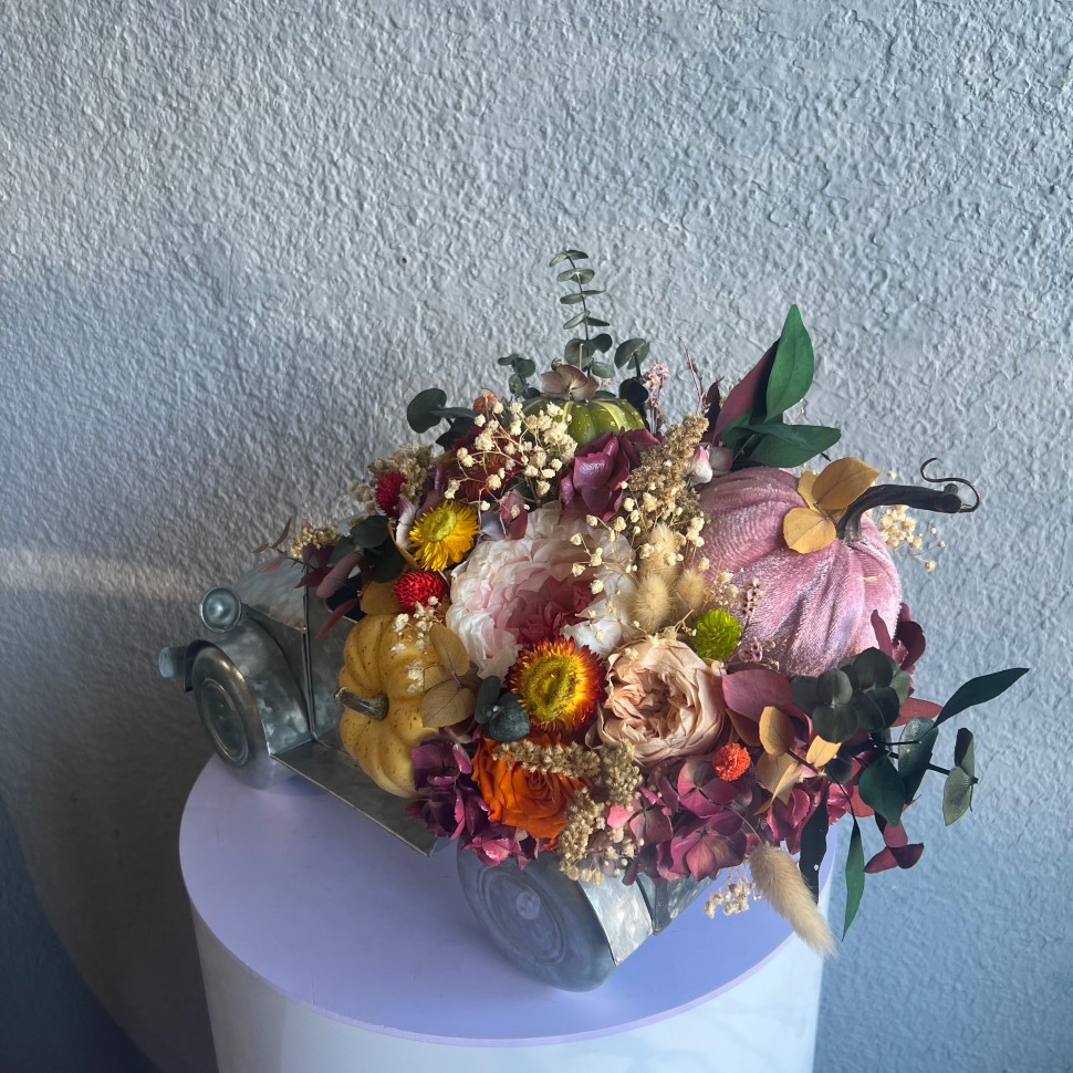 Thanksgiving arrangement with preserved flowers in iron car