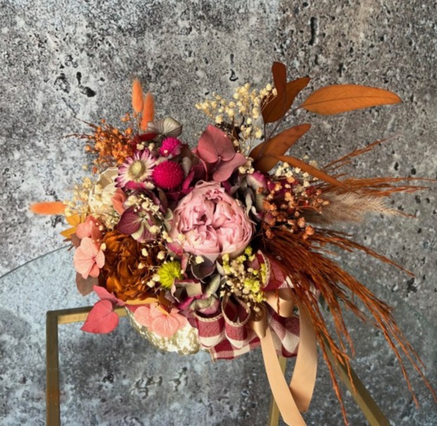 Thanksgiving arrangement with preserved flowers in gold pumpkin