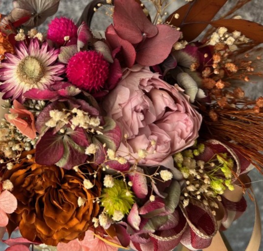 Thanksgiving arrangement with preserved flowers in gold pumpkin