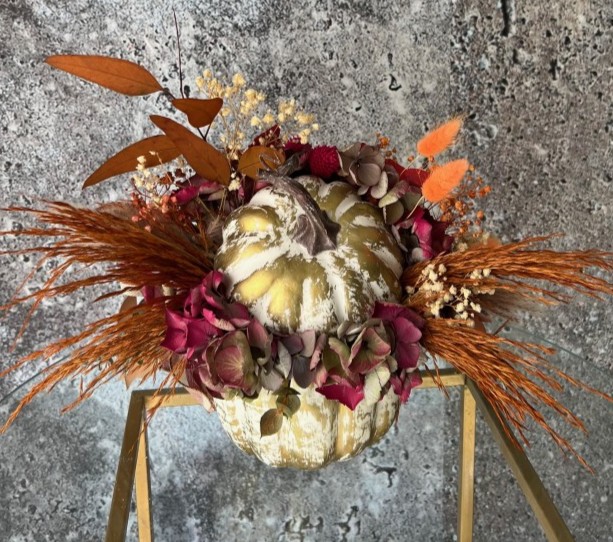 Thanksgiving arrangement with preserved flowers in gold pumpkin