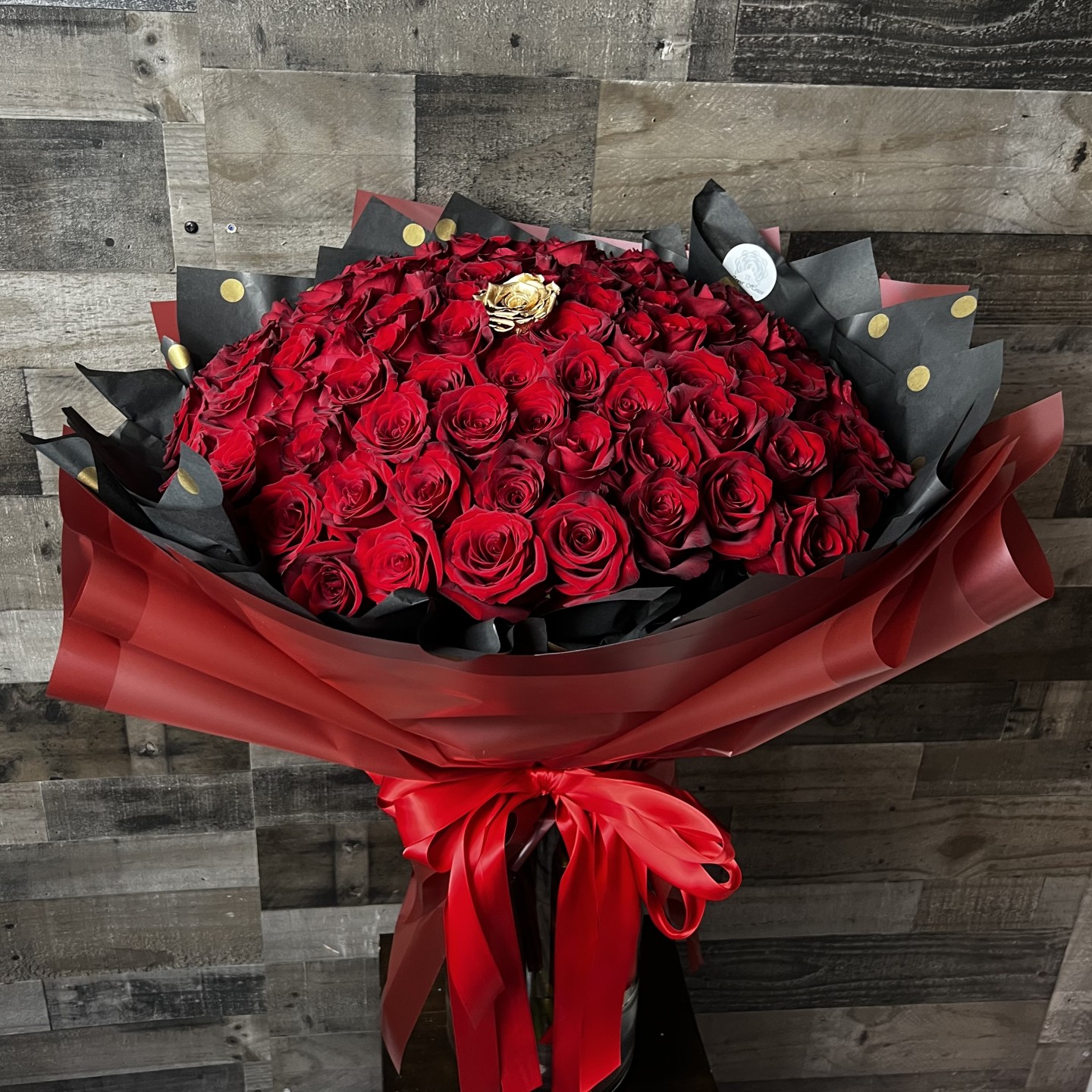100 Red Roses With 1 Gold Rose In The Middle Hand-Tied Bouquet