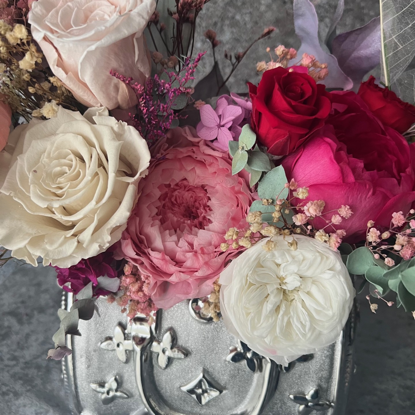 Silver bag vase with preserved flowers Silver bag vase with preserved flowers