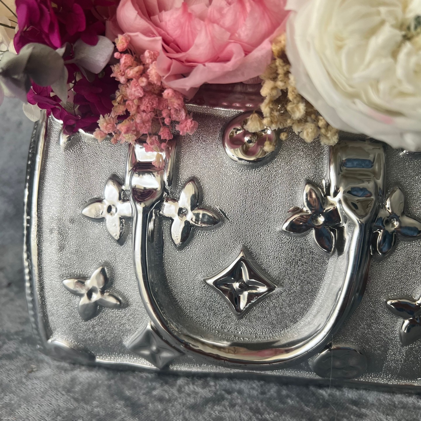 Silver bag vase with preserved flowers Silver bag vase with preserved flowers