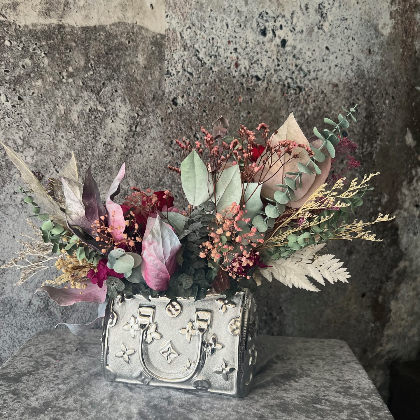 Silver bag vase with preserved flowers Silver bag vase with preserved flowers