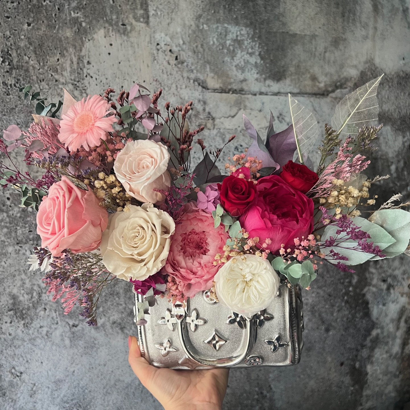 Silver bag vase with preserved flowers Silver bag vase with preserved flowers