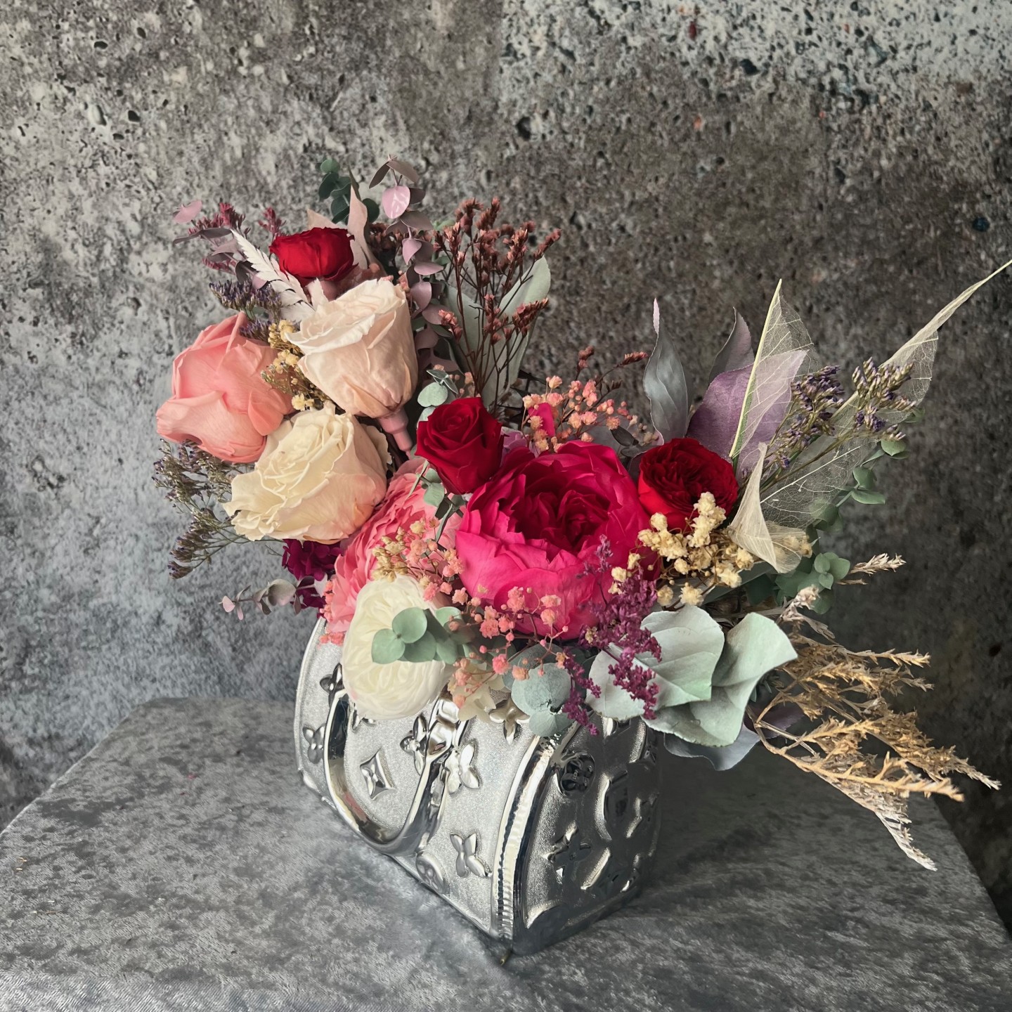 Silver bag vase with preserved flowers Silver bag vase with preserved flowers